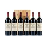 four bottles of red wine in a wooden box