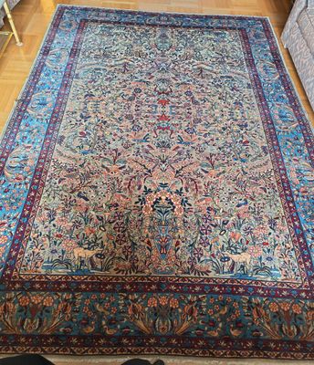 a large persian rug on a wooden floor in a living room