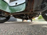 a close up view of a green motorcycle parked on the street