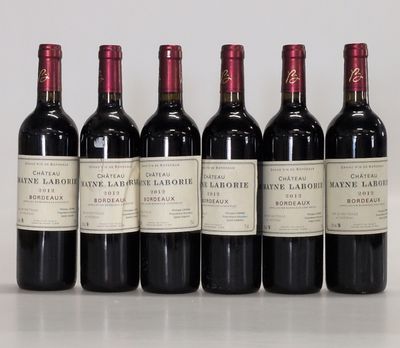 six bottles of red wine lined up in a row on a table