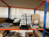 many boxes of electrical equipment on a shelf in a warehouse