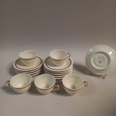 several cups and saucers sitting on top of a white table
