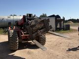 a man standing next to a tractor that is parked on the side of the road