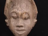 a close up of a wooden sculpture of a woman ' s face
