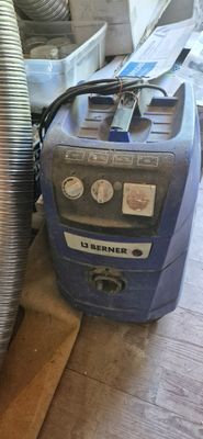 an image of a vacuum cleaner sitting on the floor next to a pile of junk