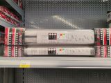several rolls of toilet paper are stacked on a shelf in a store