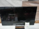 a flat screen tv sitting on a table with a price tag