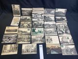 a bunch of old postcards are on a black table