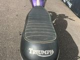 a purple motorcycle parked in a parking lot
