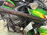 a close up of a green motorcycle parked in a garage