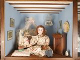 a doll that is sitting inside of a display case
