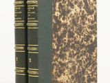 two books sitting on top of each other on a white surface