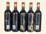 four bottles of wine are lined up in a row