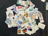a pile of stamps sitting on a black table