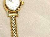 a watch that is laying on a white surface