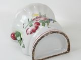 a small white cup with a floral design on it