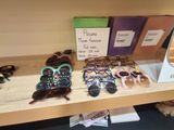 several pairs of sunglasses are displayed on a shelf in a store