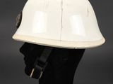 a white helmet on a black mannequin head on a black background