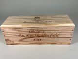une boîte en bois sur laquelle est inscrit un nom, posée sur une table