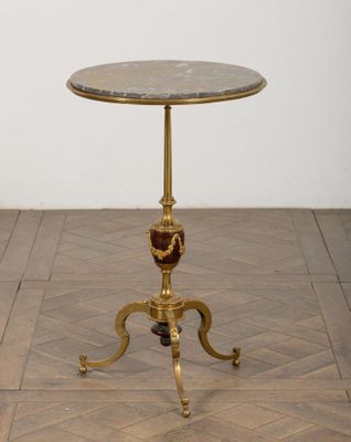 une photo d'une petite table avec un plateau en marbre posée sur un parquet