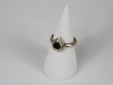 a close up of a ring on a white cone on a white surface