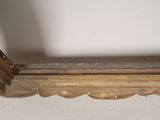 a wooden shelf with a metal handle on top of it