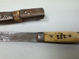 two knives that are sitting next to each other on a table