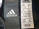 the back of a black adidas jacket with a white logo on it