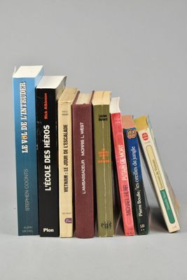 a lot of books that are stacked on top of each other