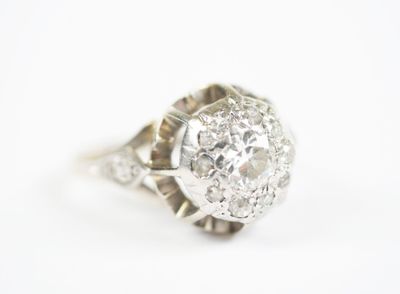 a close up of a diamond ring on a white surface