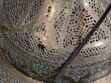 a close up of a large metal object with intricate designs