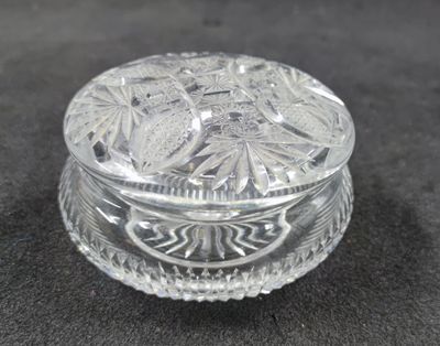 a small glass box with a lid on a table
