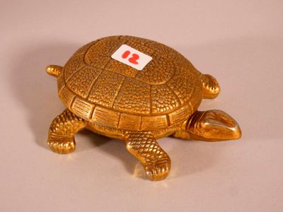 a gold turtle with a red tag on its shell