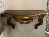 a picture of a wooden shelf with a mirror above it