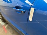 a close up of a car door handle with a sticker on it