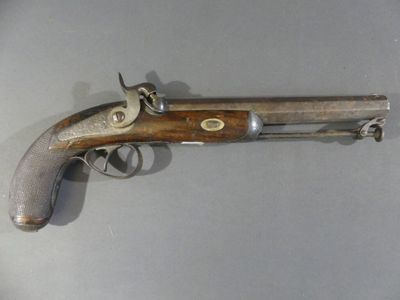 an old gun that is on display on a table