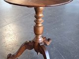 a wooden table with a wooden top on a black tile floor