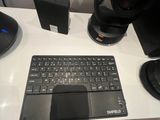 a desk with a keyboard, mouse and speakers on it