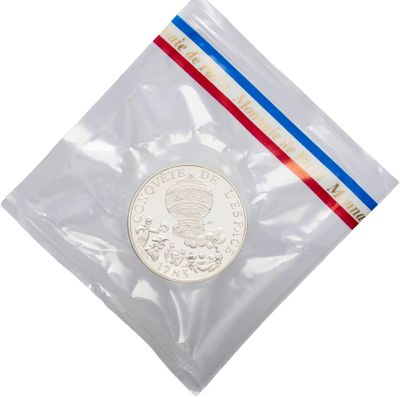 a coin in a plastic bag with a red, white and blue stripe
