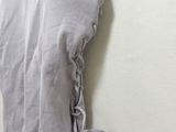 purple dress hanging on a hanger against a white wall