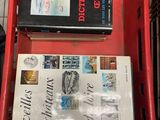 two books in a red basket on a table