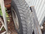 a tire that is sitting on the ground next to a fence