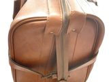 a brown leather bag with a zipper on it