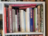 a book shelf with many books on it in a room