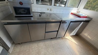stainless steel counter top in a kitchen with a microwave on it