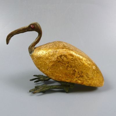 a golden bird that is sitting on a table