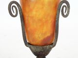 a vase that is sitting on a stand on a white surface