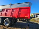 a red dump truck that is parked on the side of the road
