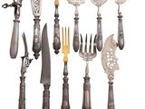 many different types of knives and spoons on the table