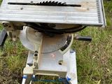 a table saw sitting on the ground in the grass